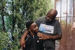 Ziare Gearring (left) and his grandfather Ricky Brown pose for a portrait outside of their home in Los Angeles. The 65-year-old retired handyman had already been struggling, and taking in three grandsons after his ex-wife's sudden death has put him thousands of dollars behind on rent and utilities.