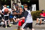 Rex Stewart, left, looks to pass during a game in the Rip City 3-on-3 Basketball Tournament. Stewart's team won the unified bracket in the tournament's inaugural year.