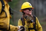 Raegan McKinney, who is 19 and starting her second wildland firefighting season, communicates on her walkie-talkie as she and others work to put out a controlled burn during the annual five-day Mid-Willamette Valley Interagency Wildland Fire School.