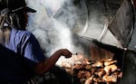 Jamaican Jerk Chicken cooks on the charcoal grill during the Notting Hill Carnival in 2006 in London.