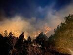 Silver City Hotshots conduct firing operations west of Holman, New Mexico, during the Hermits Peak Fire on May 9, 2022.