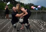 On bended prosthetic knee, Sgt. Misha Varvarych, a Ukrainian amputee and his fiancé Ira Botvynska kiss after he proposed to her in Orlando FL