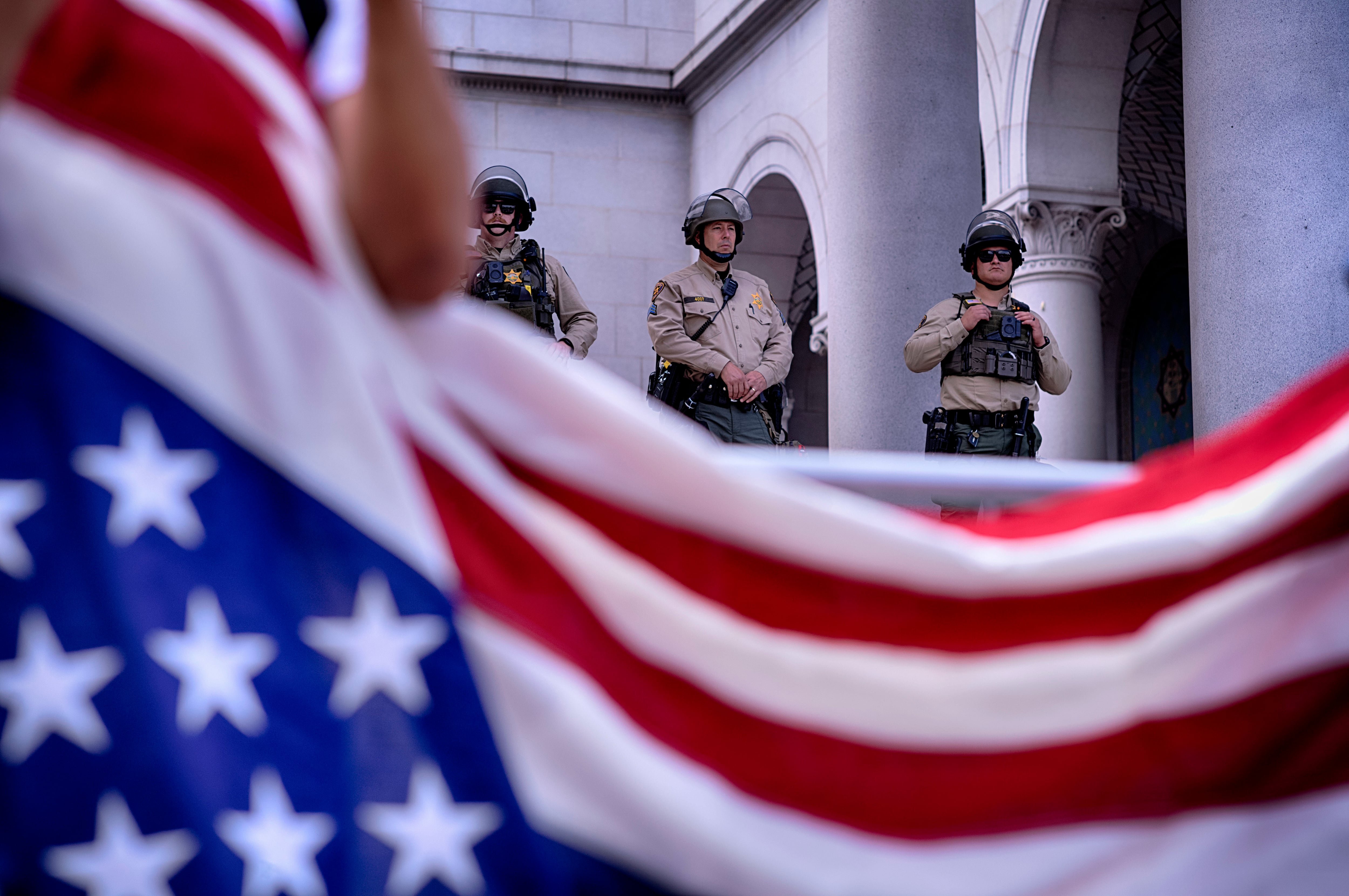 Los Angeles: Los Angeles Sheriff's deputies stand guard on the steps of Los Angeles City Hall as protesters assemble.