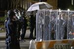 Police and protesters face one another through a chain link fence in downtown Portland the night of June 3, 2020.