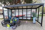 People take shelter at the city bus stop in front of City Hall in Pendleton, Ore., on May 3, 2026.