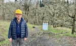 Brad van Appel, executive director of Mount Pisgah Arboretum, stands in front of a trail closed due to storm damage in Eugene, Ore., in January 2024. A winter storm caused severe damage to the natural area, taking down trees and nearby powerlines.