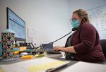 Heather Griggs, operations chief of the Umatilla County Public Health Department COVID-19 contact tracing center in Pendleton, Ore., checks in with public health staff in neighboring Morrow County about a possible workplace exposure to COVID-19 on Tuesday, July 14, 2020.