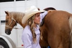 Jessie Walker walks around her horse, Goldfish, keeping a hand on the hindquarters at the Pi-Ume-Sha rodeo in Warm Springs on Saturday. Walker, a member of the Confederated Tribes of the Colville Reservation says doing rodeo isn’t common for Native Americans today—most of whom live in urban areas.