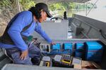 Walter Washikiat, head of a roving team of Indigenous technicians working for Kara Solar, surveys a solar boat.