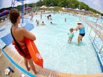 Lifeguard Maggie Storti (left) keeps an eye on visitors to the North Boundary Park swimming pool and waterpark on July 9, 2020, in Cranberry Township, Pa.