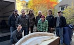 Corvallis Public Works employees and Oregon State University archaeology graduate students, shown above, moved the tusk to the library.