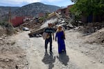 Brother and sister Boujemaa and Aicha Ounasser return home to their birthplace in the Atlas Mountains on Sept. 12 to view the rubble of the devastating earthquake in Tnirte, Morocco.