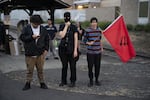 Antifa demonstrators wait for a vigil for migrants who have died in ICE custody to begin in front of the Portland ICE office on July 17, 2019 in Portland, Oregon. 