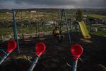 A boy sits on a swing in a playground in the Palestinian village of Susya in the occupied West Bank.