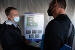 FILE: Larry Covey, left, of the Washington Department of Social and Health Services, discusses a proposed psychiatric campus in Vancouver with potential neighbor Tyler Castle on Nov. 4, 2021. The 48-bed campus has been proposed to decentralize psychiatric care from the state hospitals.