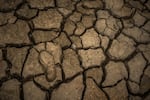 A footprint on a dry section of reservoir at El Guavio Reservoir on April 18, in Gachalá, Colombia. Reservoirs around Colombia are at low water levels due to a major drought caused by El Niño.