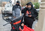 After arriving at The Old Church and finding the COVID-19 testing site closed, Mr. Jones (left) and his wife (no first names given) scramble to find an alternative, Jan. 6, 2022. The family had been exposed to COVID-19 and their 11-month-old child Lorenzo came down with a fever. 