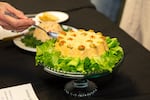 A judge tries a savory gelatin salad at the Holiday Gelatin Salad Show in Bend, Ore., on Dec. 13, 2025.