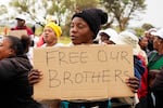 Relatives and friends protest near a reformed gold mineshaft where illegal miners are trapped in Stilfontein, South Africa