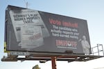 A billboard shown on Thursday, Oct. 8, 2026 stands on the northbound side off Business 97 in Bend, Ore. It depicts a fake newspaper and headlines alongside a real image of Deschutes County Commissioner candidate Rob Imhoff. The billboard discloses using AI.