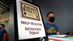 A hiring sign is placed at a booth for Jameson's Irish Pub during a job fair Wednesday, Sept. 22, 2021, in the West Hollywood section of Los Angeles.
