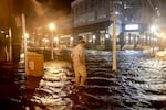 Brandon Marlow walks through surge waters flooding the street after Hurricane Milton came ashore in the Sarasota area in Fort Myers, Florida.