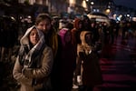 Spectators gather outside France's iconic Notre Dame Cathedral Saturday, Dec. 7, 2024 in Paris for it's formal reopening for the first time since a devastating fire nearly destroyed the 861-year-old landmark in 2019. (AP Photo/Louise Delmotte)