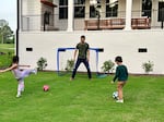 Jim Xiao paid an agent a flat $10,000 fee to help him buy a home in Evans, Ga., last year. Here, Xiao and his children play soccer at their new home.