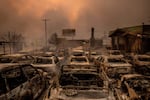 Wednesday, Jan. 8: Fire-damaged vehicles are lined up at a dealership after the Eaton Fire swept through Altadena, Calif.