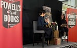 Portland author SenLinYu (left) discusses their dark fantasy novel "Alchemised" with Powell's bookseller Carly Jonathan during a sold out event at Powell's Cedar Hills Crossing in Beaverton on Feb. 10, 2026.