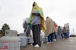 Carlos Mandez waits in line to fill his propane tanks Wednesday, Feb. 17, 2021, in Houston. Customers had to wait over an hour in the freezing rain to fill their tanks. Millions in Texas still had no power after a historic snowfall and single-digit temperatures created a surge of demand for electricity to warm up homes unaccustomed to such extreme lows, buckling the state's power grid and causing widespread blackouts.