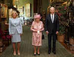 June 13, 2021:  Queen Elizabeth II (center) with President Joe Biden and First Lady Jill Biden in the Grand Corridor during their visit to Windsor Castle in Windsor, England.