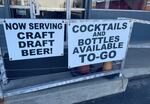 Signs outside MichiGrain Distillery in Lansing, Michigan advertise cocktails-to-go. Michigan is among the vast majority of states that legalized carryout liquor at some point during the COVID-19 pandemic to provide financial relief to struggling restaurants and bars.