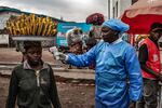 A health worker takes a woman's temperature as part of Ebola screening efforts on June 24, 2026 in Goma, Democratic Republic of Congo. 