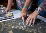 On June 9, 2024, Crook County resident Dick Zimmerlee shows Sen. Jeff Merkley a map showing water test results in relation to a Knife River gravel mining site.