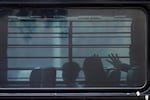 A family from Cuba is detained and loaded on to a bus with tinted windows and bars following an appearance at immigration court, Wednesday, June 11, 2025, in San Antonio. Immigration officers have ramped up enforcement outside of courtrooms across the country.