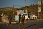 Israeli security forces inspect the scene where, according to police, a Palestinian man was shot and killed after ramming his car into a security checkpoint and seriously wounding an officer, near the West Bank Jewish settlement of Beit Horon, Wednesday, Sept. 23, 2026.