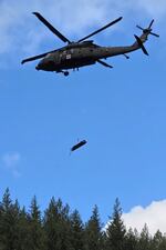 In this handout photo provided by the Estacada Fire District, an Oregon Army National Guard helicopter rescues an injured logger from Mount Hood National Forest, Thursday, March 9, 2026, after rough terrain prevented other means of rescue.