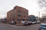 The Sundial is located between neighborhood houses and a larger mixed-use building along Nicollet Avenue.