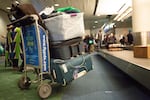 Supporters of House Bill 2508 welcome a family of 11 as they arrive to PDX after a near 36 hour trip from the Democratic Republic of the Congo on Tuesday, Feb. 5, 2019, in Portland, Ore.