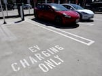 Tesla cars recharge at a Tesla Supercharger station in Pasadena, Calif., on April 14, 2022. The pivot to electric cars depends not only on the automakers ability to produce these cars. It also depends on building the infrastructure needed to support having more electric cars on the roads.