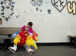 Alice Robinson takes off her skates and a chicken costume after a performance at the Lloyd Center on the last day of the mall being open.