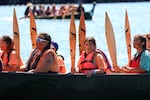 Aaliyah James,11, Pacheedaht, raises her paddle while sitting in the canoe Sea Foam Dancer, waiting for the Pacheedaht First Nation canoe family to be granted permission to come ashore on July 31, 2024.