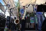 Peter Moss switches between his baritone saxophone and a tenor saxophone while performing with the Norman Sylvester Band.