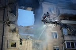Rescuers work the scene of a building damaged by Russian missile attack in Kyiv, Ukraine, Monday, July 6, 2026.
