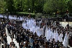 Penitents from the La Paz brotherhood parade in the Palm Sunday procession in Seville on March 29, 2026.
