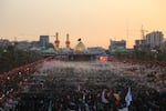 Large crowds of pilgrims fill the area between the two holy shrines in Karbala at sunset