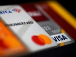 This illustration picture shows debit and credit cards arranged on a desk on April 6, 2020 in Arlington, Va. Americans are using their credit cards more to pay for everyday expenses at a time when interest rates are rising.