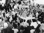 A police officer escorts a protestor to a squad car surrounded by dozens of anti-Vietnam War demonstrators outside the 1968 Democratic National Convention in Chicago. (Photo by Hulton Archive/Getty Images)