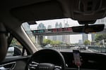 A DiDi ride-hailing driver travels through the financial district in Shanghai on April 9.